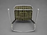 an image of a metal chair with a green cushion on it