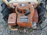 a lawn mower that is sitting on the ground