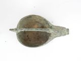 a metal object that is sitting on a white surface