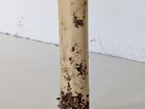 a close up of a metal pipe with dirt all over it