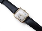 an image of a close up of a wrist watch on a white surface