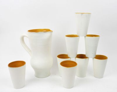 a lot of cups and a pitcher on the table