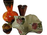 three vases and a bowl sitting next to each other