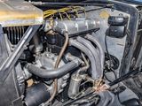 a close up view of a car engine with the hood open