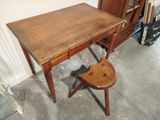 a small wooden desk with a chair in front of it