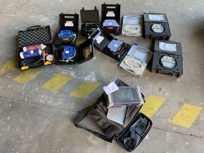 several pieces of luggage sitting on the ground next to a parking lot