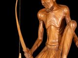 wooden sculpture of a man with a bow and a hat