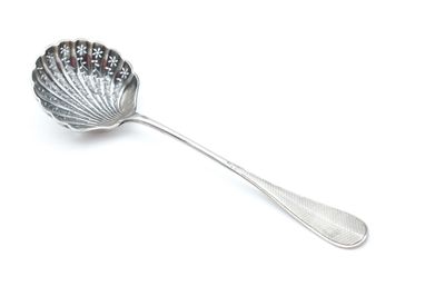 silver spoon with a flower design on it on a white surface