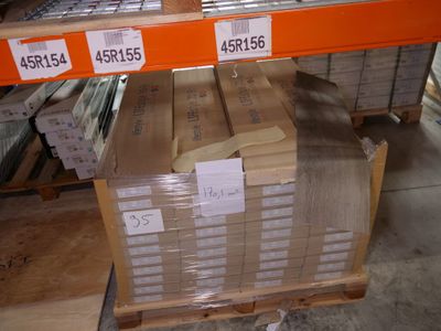 a large stack of boxes sitting on a pallet in a warehouse