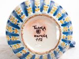 a blue and white plate with a yellow and blue design on it