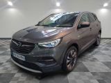 the grey opel suv is parked in a room with a checkered floor