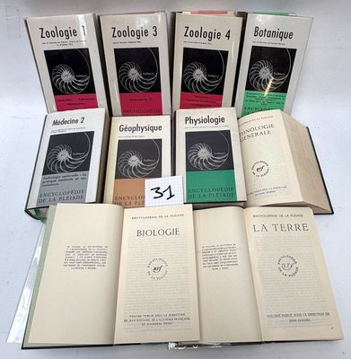 several books are stacked on top of each other on a table