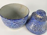 a blue and white bowl and a blue and white bowl on a white surface