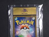 the pokemon card is in a plastic case on a black surface