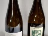 three bottles of wine sitting on a table next to each other
