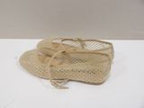 beige shoes with lace on them on a white surface