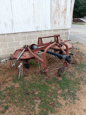 a rusted out plow in front of a building