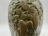 a vase with a design on it on a white surface