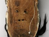 a piece of wood that has a face on it