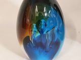 a glass ball with a blue and green design on it