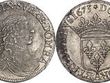 a silver coin with a crown on top of it