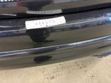 a sticker on the bumper of a car that is parked in a parking lot