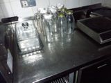 a stove top with a lot of glass bottles on it