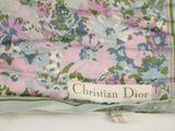 a pink and blue floral scarf with a name tag on it