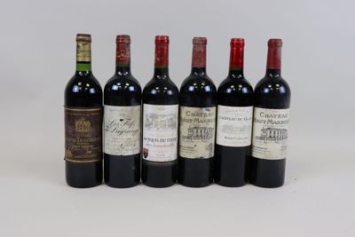 six bottles of wine are lined up on a white surface