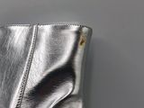 silver leather boots with a zipper on the side of them