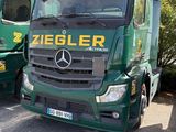 deux camions verts garés l'un à côté de l'autre sur un parking