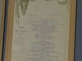 three menus hanging on the wall next to each other