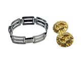 a close up of a bracelet and a pair of earrings on a white background
