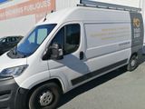 a white van that is parked in front of a building