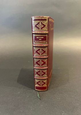 an old book sitting on top of a table next to a white wall