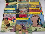 several children ' s books are lined up on a table