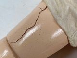 a wooden dummy with a bandage on it ' s arm