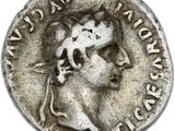 une pièce d'argent sur laquelle figurent le buste d'une femme et un chat