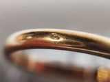 a close up of a gold ring with a diamond on it