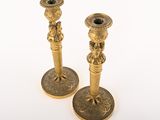 pair of antique brass candlesticks on a white background