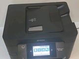 a printer that is sitting on a table next to a mouse