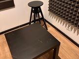 a black table and a stool in a room