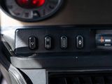 a close up of a car dashboard with a red light
