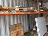 a pile of wood on a shelf in a garage
