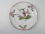a plate with a bird on it on a table