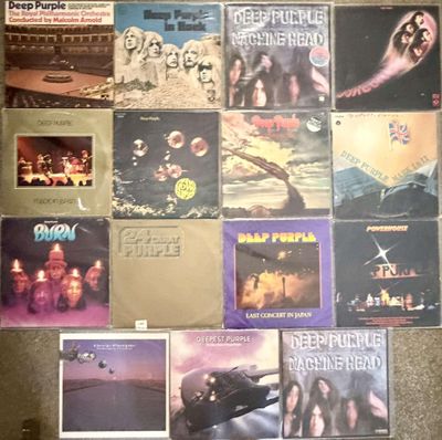 various albums and cds are arranged on a carpeted floor