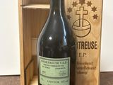a bottle of wine sitting in front of a wooden box