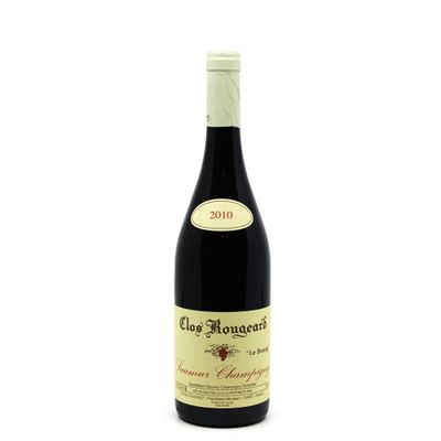 a bottle of red wine sitting on top of a white table