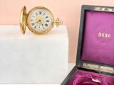 a small box with a watch in it and a ring in it