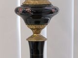 a lamp that is sitting on a table next to a wall